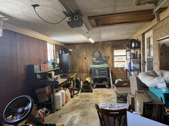 interior space featuring concrete flooring, a workshop area, and wood walls