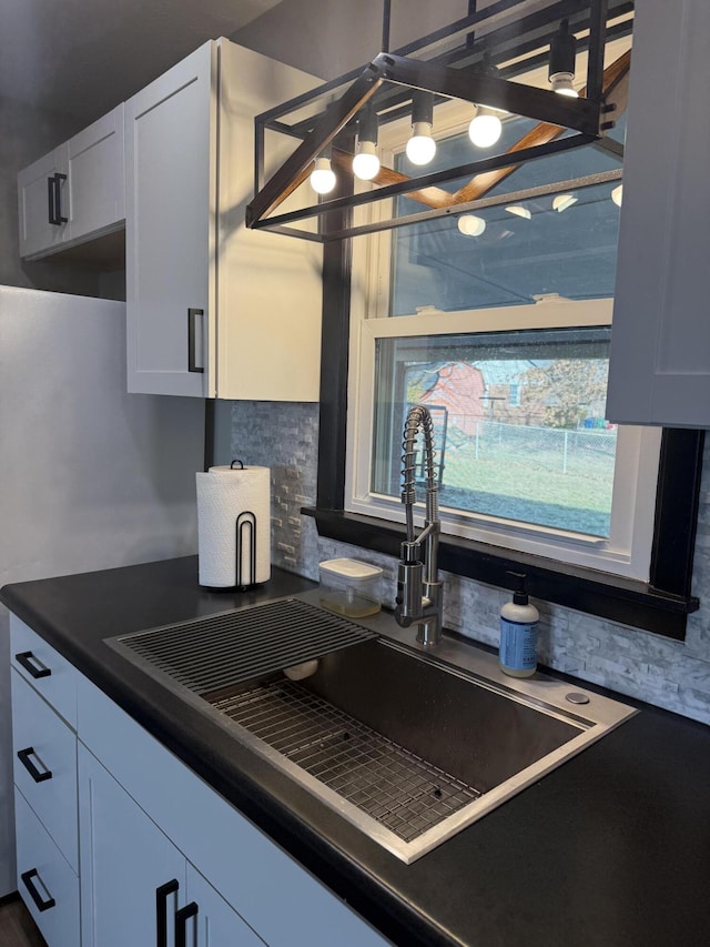 kitchen with white cabinetry and sink