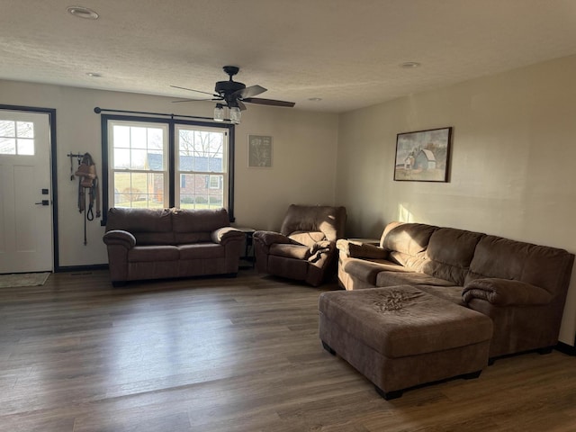 living room with ceiling fan, hardwood / wood-style floors, and a textured ceiling