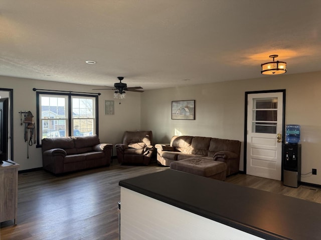 living room with dark hardwood / wood-style floors and ceiling fan