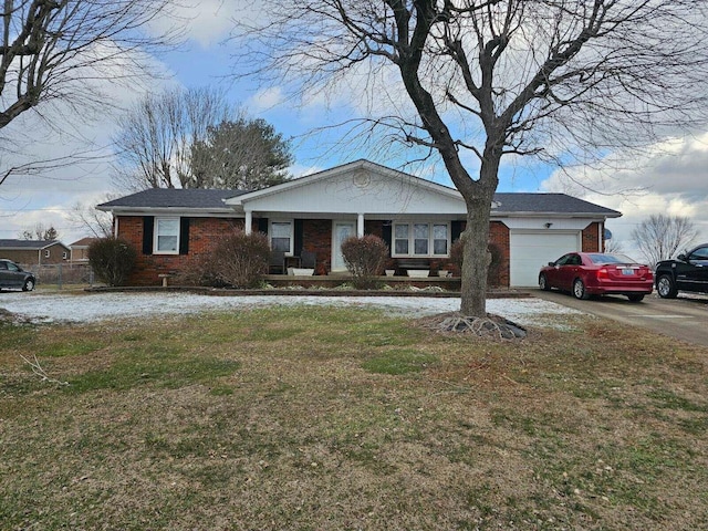 view of front of house with covered porch, a front yard, and brick siding