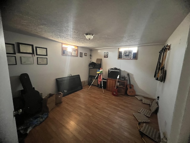 interior space with hardwood / wood-style floors and a textured ceiling