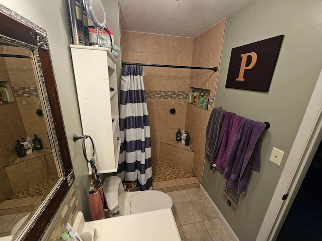 full bath featuring tile patterned flooring, toilet, a shower stall, and a textured ceiling