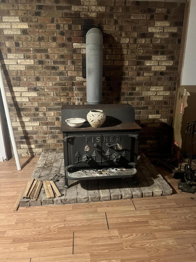 room details with a wood stove and wood finished floors