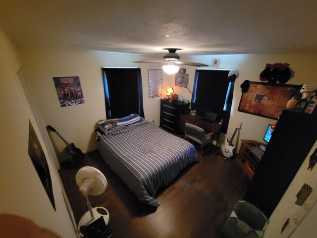 bedroom featuring a ceiling fan and wood finished floors