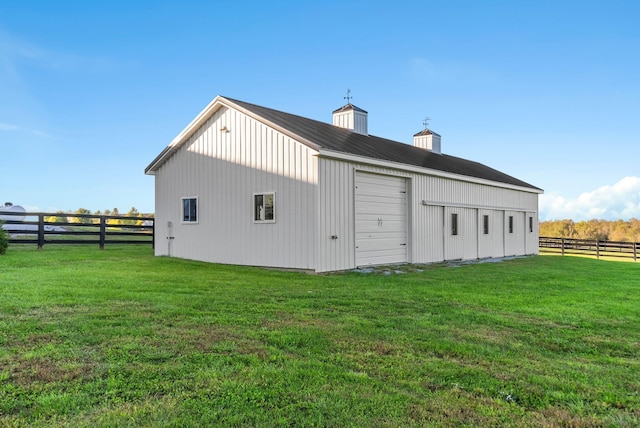 view of side of property featuring an outbuilding, a yard, and a garage