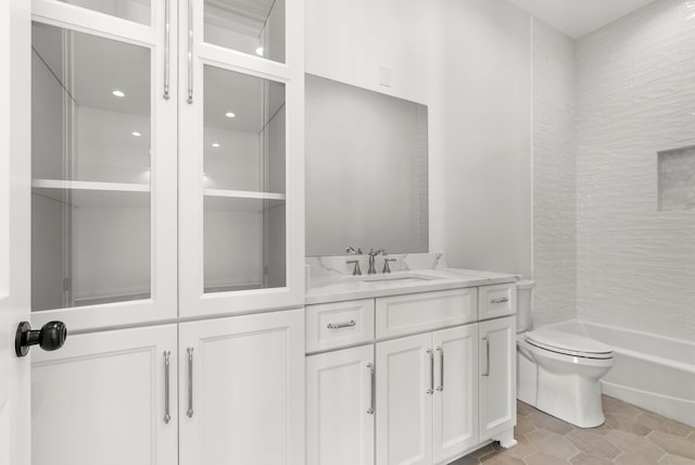 bathroom featuring vanity, tile patterned floors, and toilet