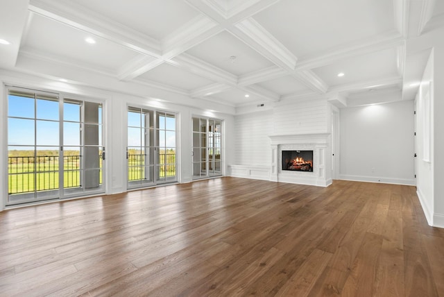 unfurnished living room with crown molding, wood-type flooring, coffered ceiling, and beam ceiling