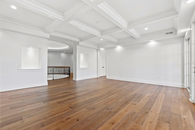 unfurnished living room featuring coffered ceiling, hardwood / wood-style flooring, crown molding, and beamed ceiling