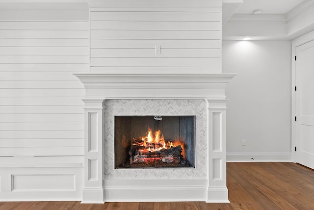 room details featuring a fireplace and wood-type flooring