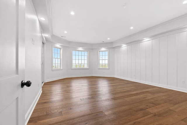 empty room with dark wood-type flooring and crown molding