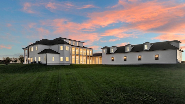 back house at dusk with a yard