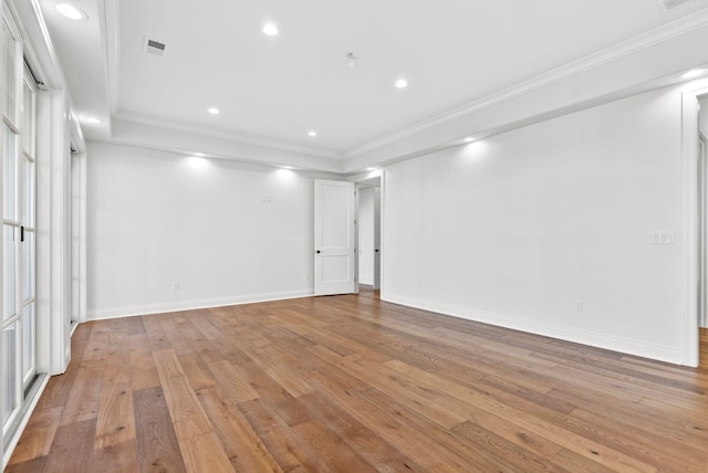 empty room with ornamental molding and light wood-type flooring