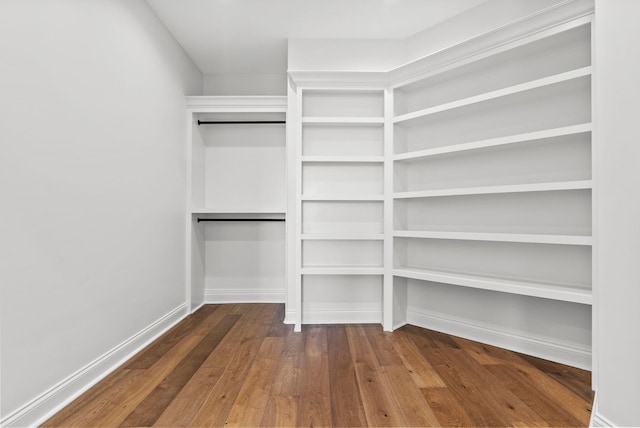 walk in closet with hardwood / wood-style flooring