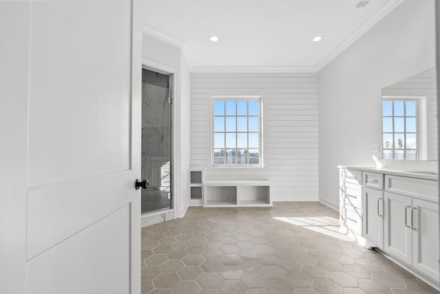 bathroom with vanity, a shower, and crown molding