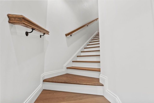 staircase with hardwood / wood-style flooring