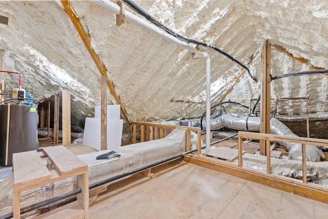 unfinished attic featuring water heater