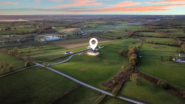 aerial view at dusk featuring a rural view