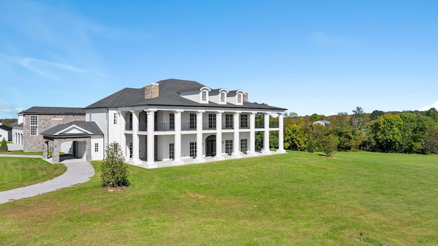 rear view of house featuring a lawn