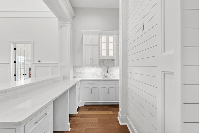 interior space with hardwood / wood-style flooring, sink, and backsplash