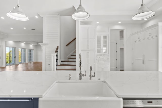 kitchen with hanging light fixtures and light stone counters