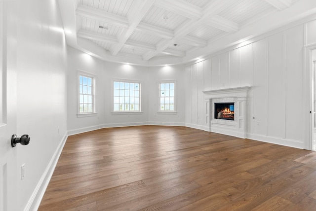 unfurnished living room with coffered ceiling, beam ceiling, and dark wood-type flooring