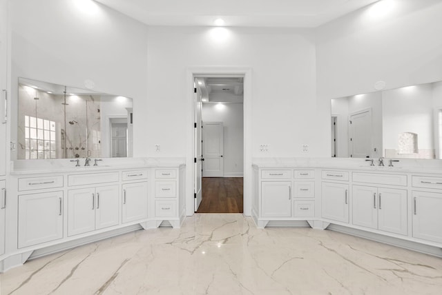 bathroom with vanity, a towering ceiling, and a shower with shower door