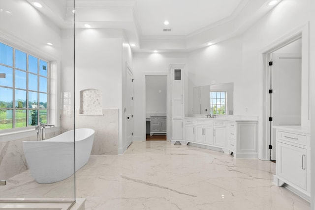 bathroom featuring tile walls, a tub to relax in, a high ceiling, vanity, and crown molding