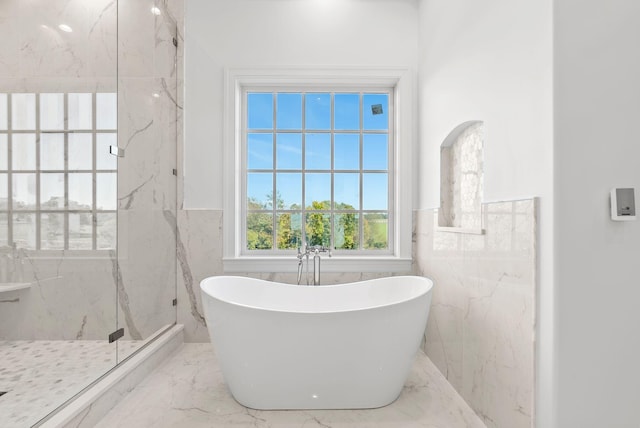 bathroom featuring separate shower and tub