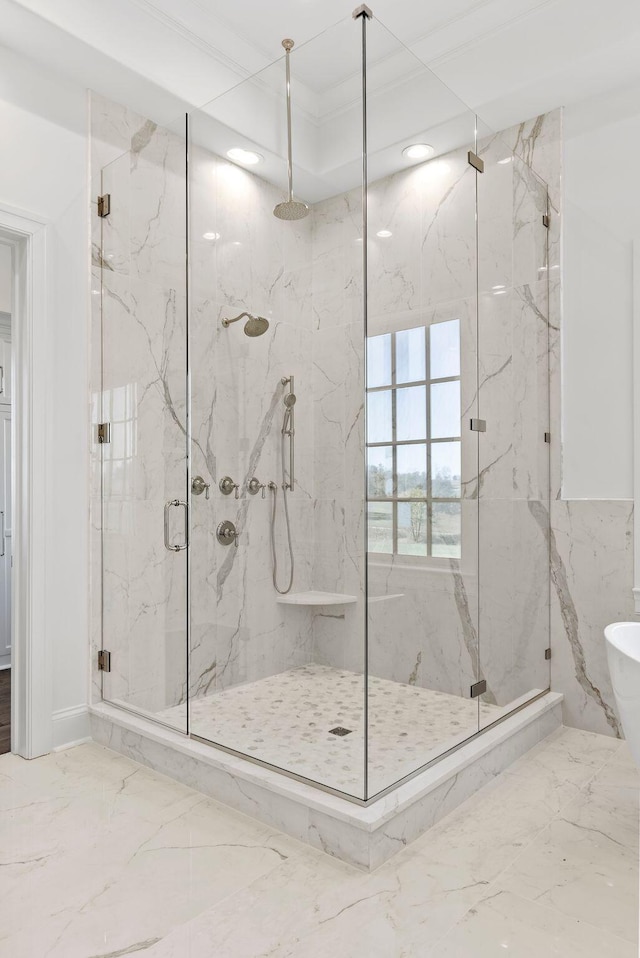 bathroom with crown molding and an enclosed shower