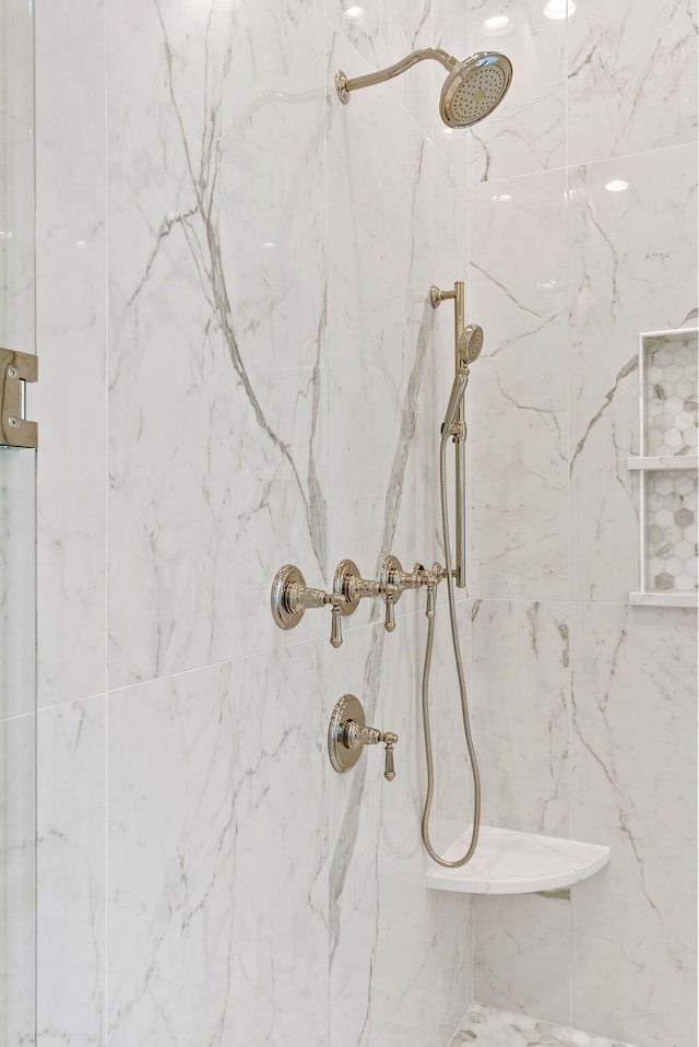 interior details with a tile shower