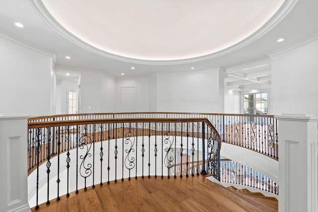 corridor featuring crown molding, wood-type flooring, coffered ceiling, and beam ceiling