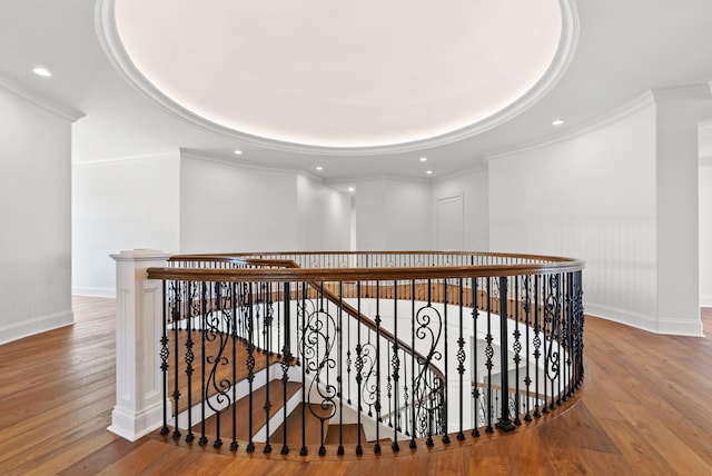 hallway with hardwood / wood-style floors and ornamental molding