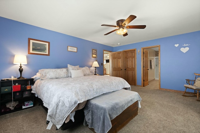 bedroom with connected bathroom, ceiling fan, and carpet