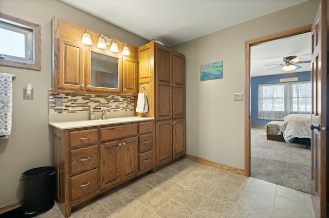 bathroom featuring vanity, ceiling fan, and decorative backsplash