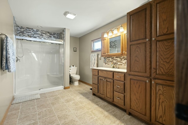 bathroom featuring vanity, toilet, an enclosed shower, and backsplash