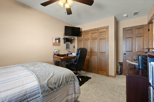 bedroom featuring lofted ceiling, carpet floors, ceiling fan, and a closet