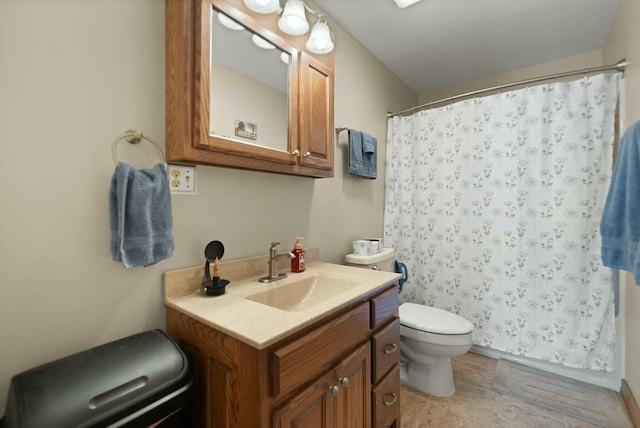 bathroom with vanity, walk in shower, and toilet