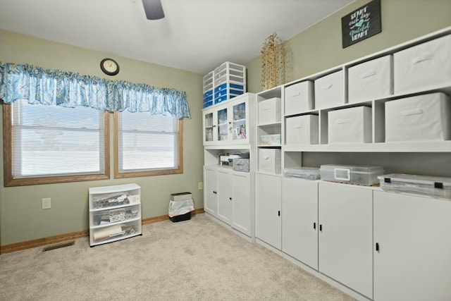 interior space featuring ceiling fan and light colored carpet