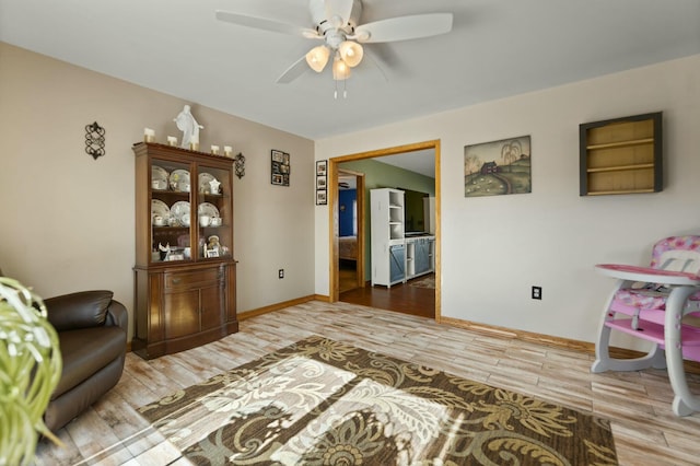 living room with hardwood / wood-style flooring and ceiling fan