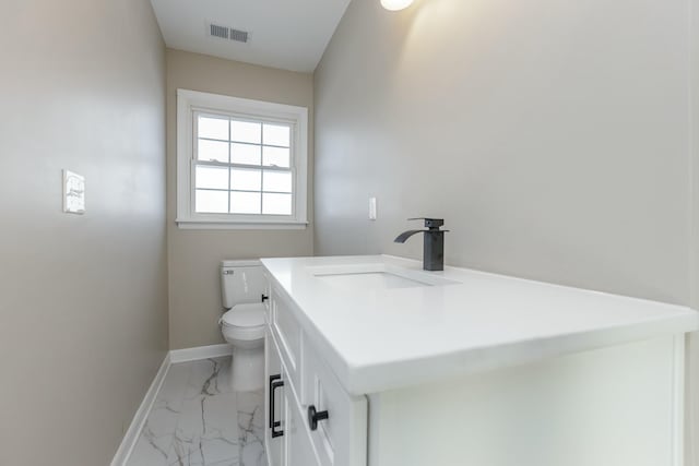 bathroom with vanity and toilet