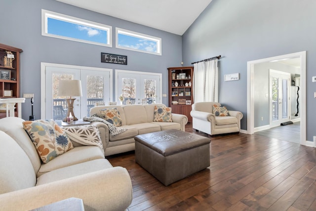 living room featuring a towering ceiling and dark hardwood / wood-style flooring