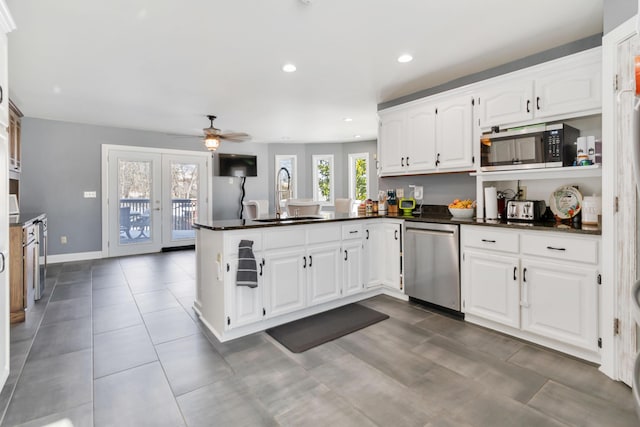 kitchen featuring white cabinetry, sink, stainless steel appliances, and kitchen peninsula