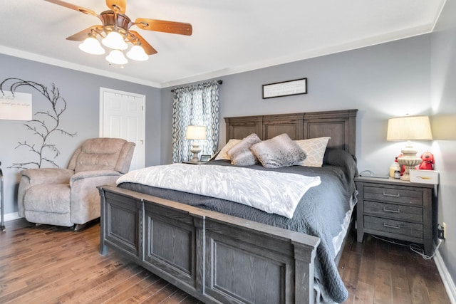 bedroom featuring crown molding, dark hardwood / wood-style floors, and ceiling fan