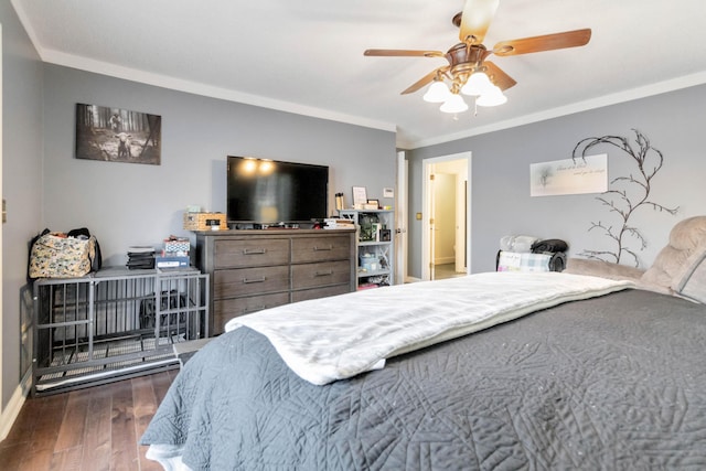 bedroom featuring crown molding, dark wood-type flooring, and ceiling fan