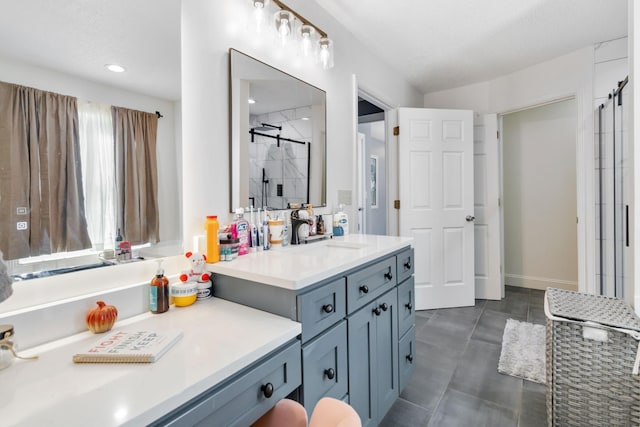 bathroom featuring vanity, a shower with door, and a textured ceiling