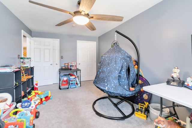 playroom with ceiling fan and carpet flooring