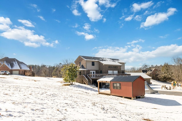 snow covered property featuring a deck