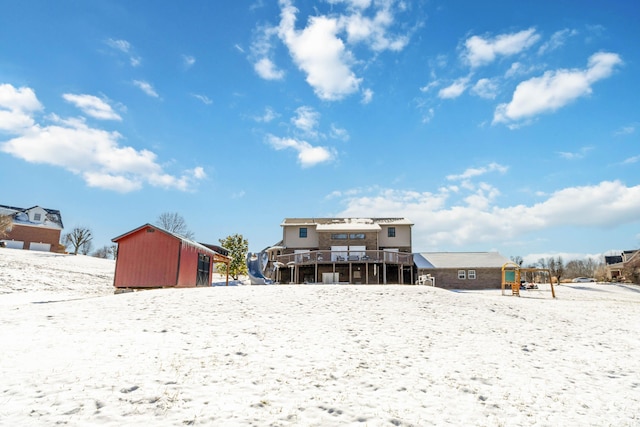 snow covered property featuring a wooden deck