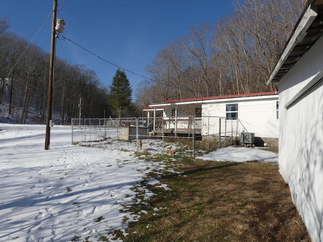613 Little Hardwicks Creek Rd, Clay City, KY 40312 - yard layered in snow with a wooden deck and central AC unit